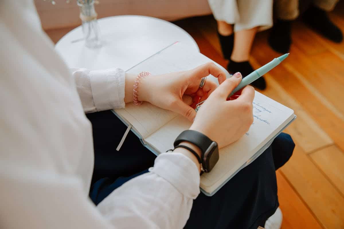 Health coach taking notes during a client coaching session