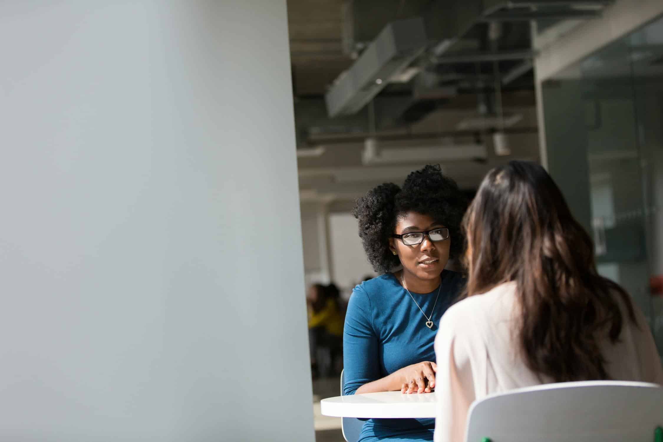 A health coach actively listening during a one-on-one coaching conversation